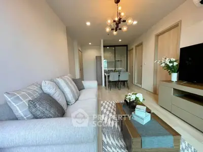 Modern living room with stylish decor and open layout leading to dining area.