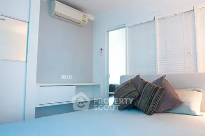 Modern bedroom with air conditioning and stylish pillows