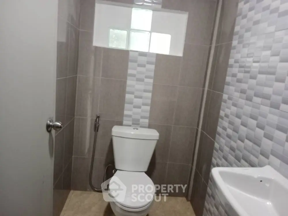 Modern bathroom with sleek tiles and compact design
