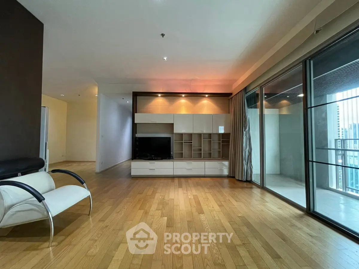 Spacious modern living room with wooden flooring and large windows