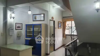 Spacious office area with modern lighting and stylish decor, ideal for professional work environment.