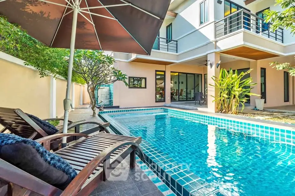 Luxurious villa with private pool and sun loungers, perfect for relaxation and entertainment.