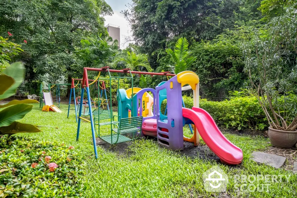 Charming garden with colorful playground set in lush greenery, ideal for family-friendly living.