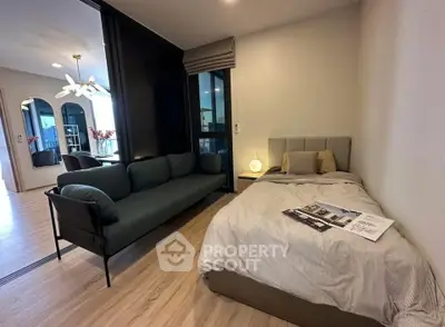 Modern studio apartment with cozy bed and stylish sofa, open layout design.