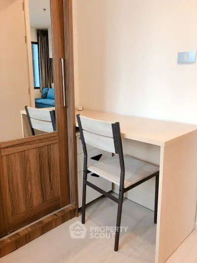 Modern study area with wooden desk and chair in a cozy apartment
