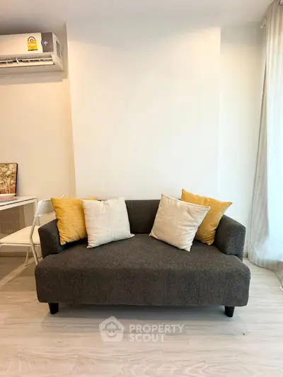 Cozy living room with modern gray sofa and stylish cushions