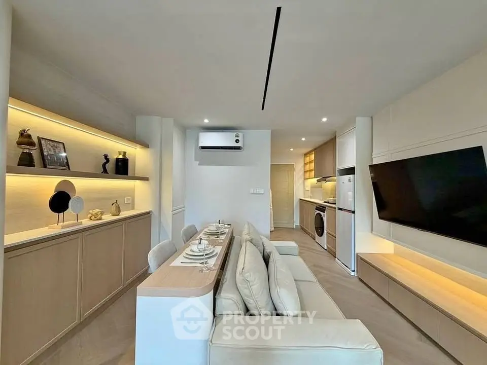 Modern living room with sleek furniture and integrated kitchen appliances
