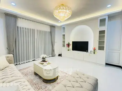 Luxurious living room with elegant chandelier and modern decor