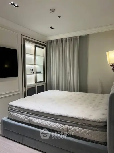 Luxurious bedroom with elegant decor and plush mattress in modern apartment.