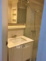 Compact bathroom with modern fixtures and glass shower enclosure