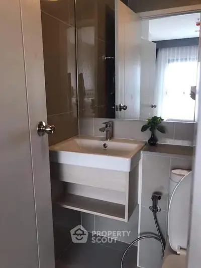 Modern compact bathroom with sleek design and contemporary fixtures.