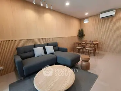 Modern living room with stylish furniture and wooden accents, perfect for cozy gatherings.