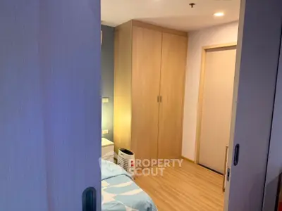 Cozy bedroom with wooden flooring and built-in wardrobe