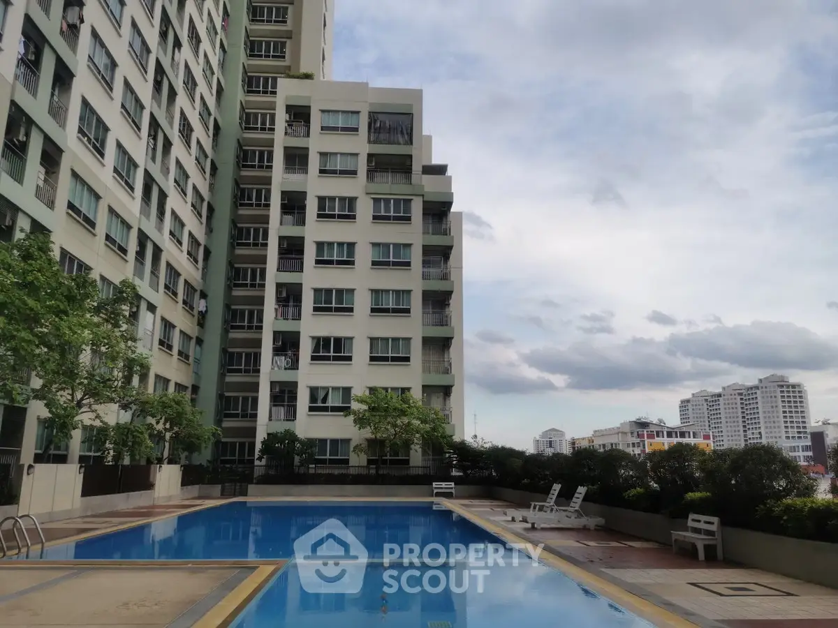 Modern apartment building with pool and city view, perfect for urban living.