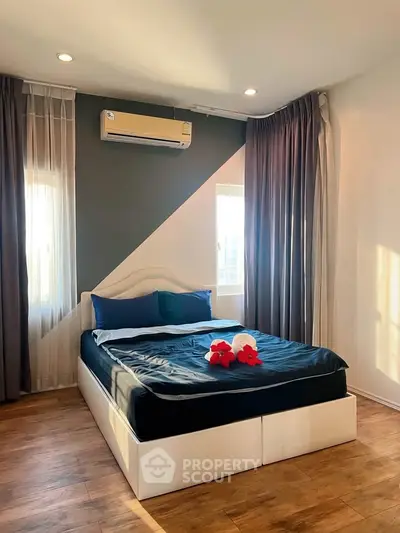 Modern bedroom with stylish decor, featuring a cozy bed, elegant curtains, and natural light.
