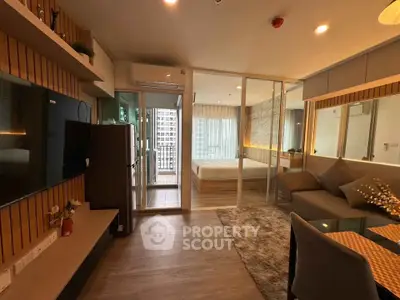 Modern open-plan living room with cozy decor and city view balcony