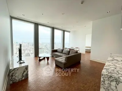 Luxurious high-rise living room with stunning city views and modern furnishings.