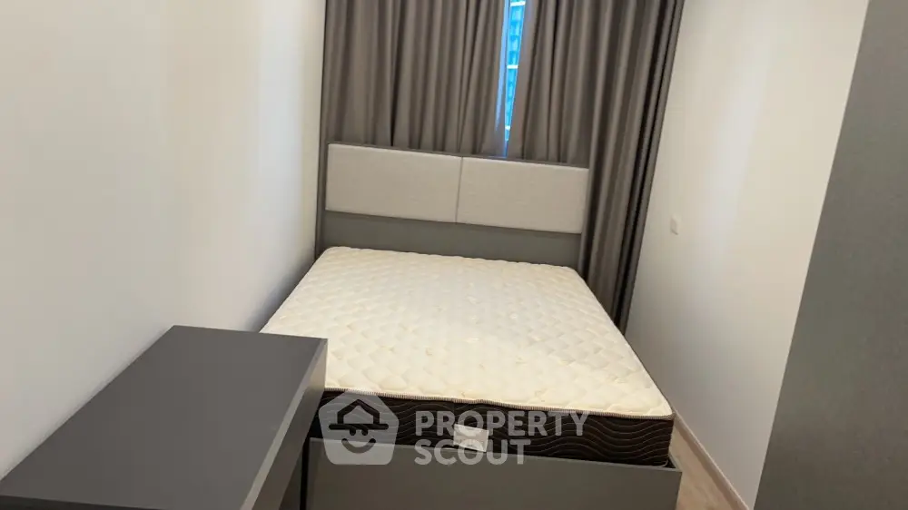 Cozy bedroom with modern bed and stylish curtains, perfect for restful nights.