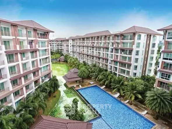 Luxurious condominium complex with pool and lush gardens offering resort-style living.