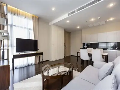 Modern living room with open kitchen and stylish furniture in a bright apartment.