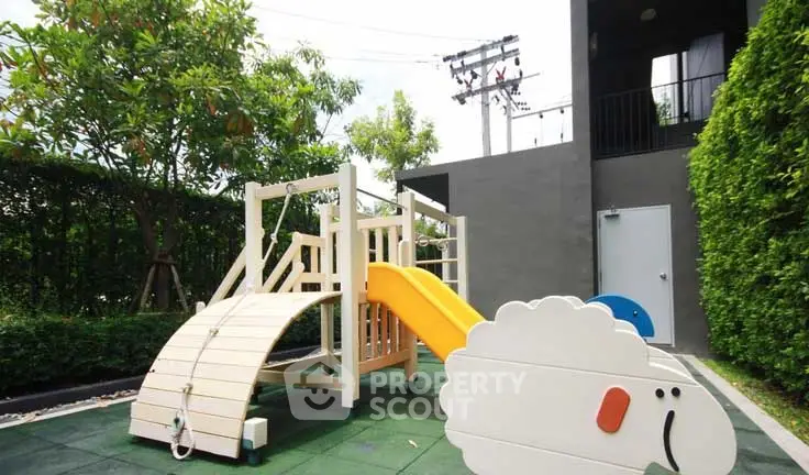 Charming residential playground with slide and greenery, perfect for family living.