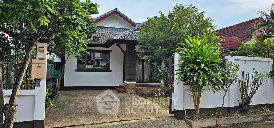Charming single-story house with lush garden and spacious driveway in a serene neighborhood.