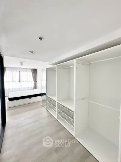 Spacious bedroom with built-in wardrobes and large windows for natural light.