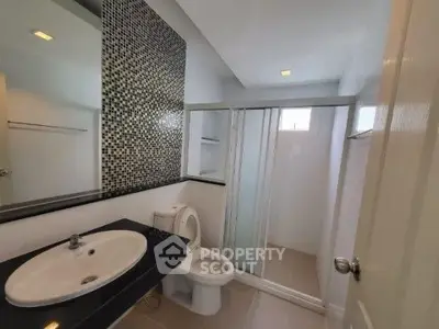 Modern bathroom with sleek design and mosaic tile accent wall