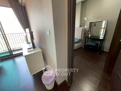 Modern apartment interior with balcony view and stylish bedroom setup.