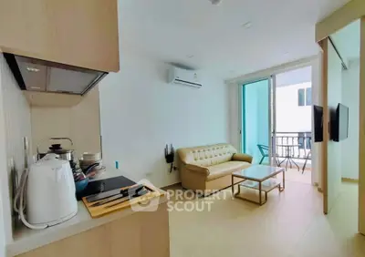 Modern open-layout living room with kitchen and balcony access