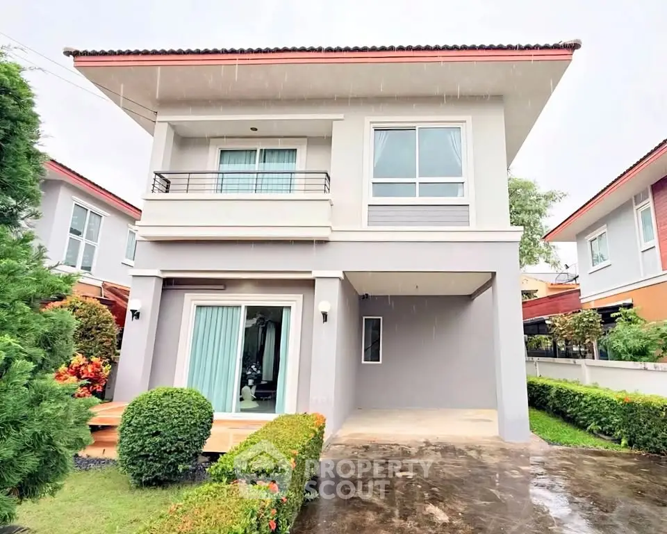 Modern two-story house with manicured garden and spacious driveway