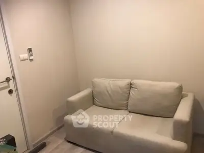 Cozy small living room with beige sofa and minimalist decor