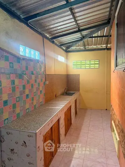 Charming rustic kitchen with colorful tiles and ample storage space.