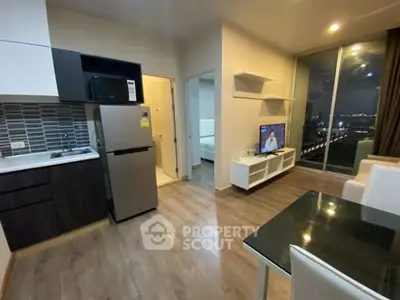 Modern apartment with open kitchen and living area, featuring sleek appliances and city view.