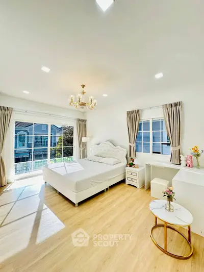 Bright and spacious bedroom with elegant decor and large windows offering natural light.