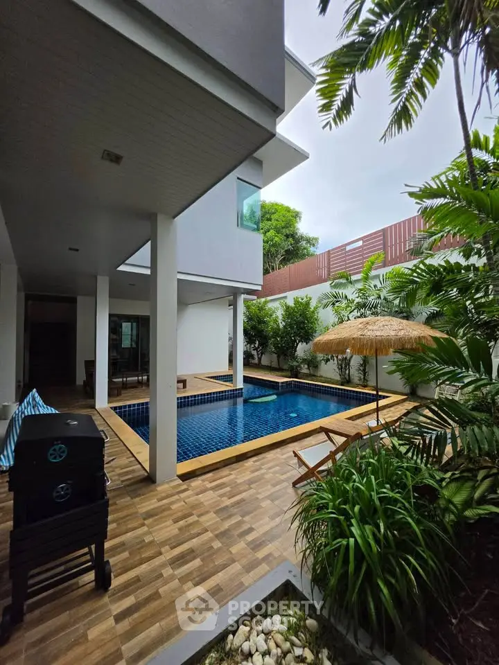 Luxurious modern villa with private pool and lush garden, perfect for relaxation and entertainment.