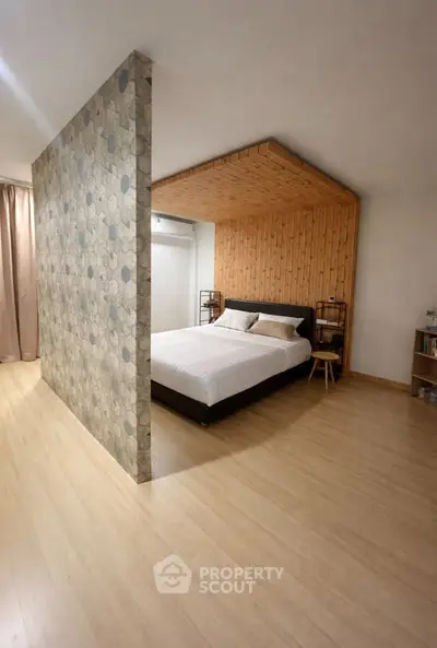 Modern bedroom with unique partition wall and wooden ceiling accent