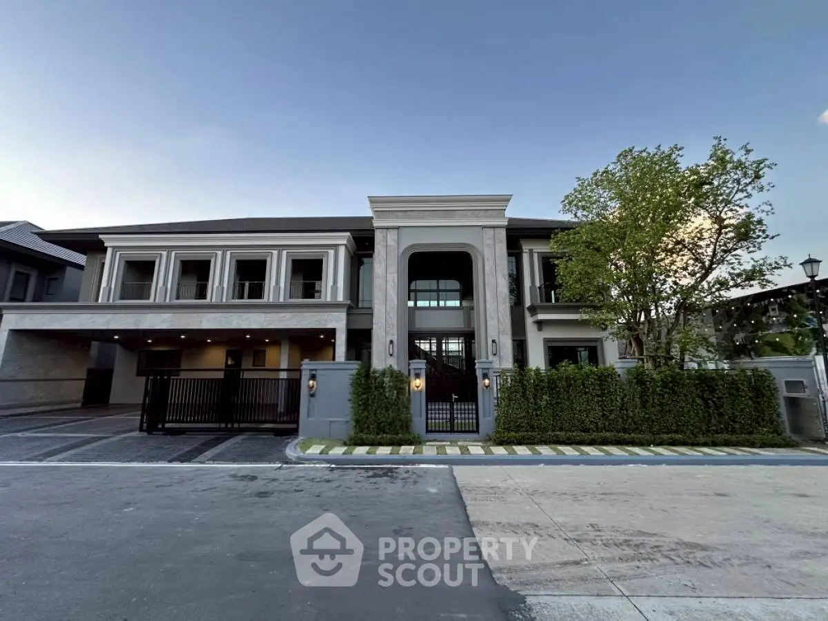 Luxurious modern mansion with grand entrance and lush landscaping