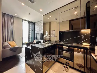 Luxurious modern kitchen with sleek black marble countertops and open layout in stylish apartment.