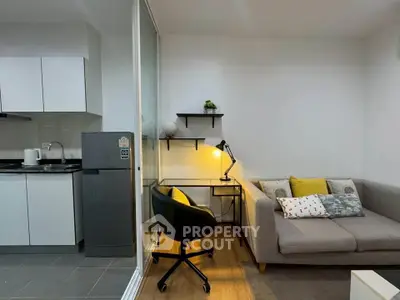 Modern studio apartment with cozy living area and compact kitchen