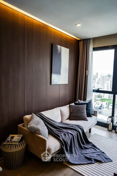 Stylish living room with city view, cozy sofa, and modern decor in urban apartment.