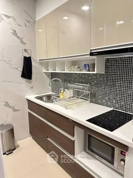 Modern kitchen with sleek cabinetry and built-in appliances