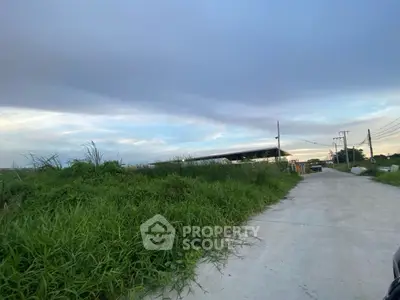 Expansive land plot with clear skies and potential for development
