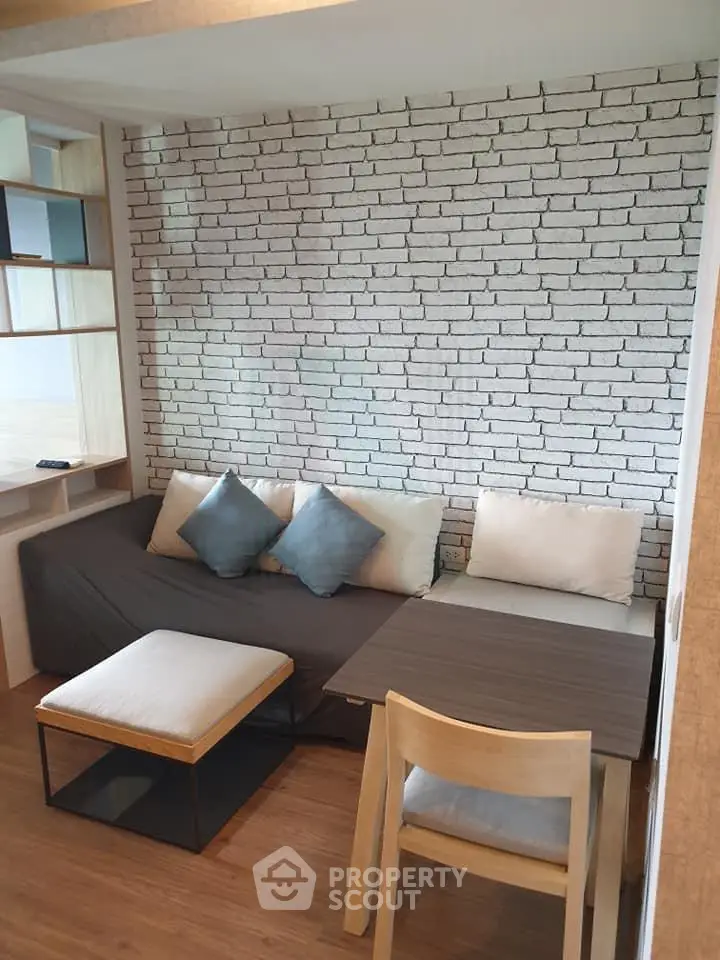 Modern living room with stylish brick wall and cozy seating area