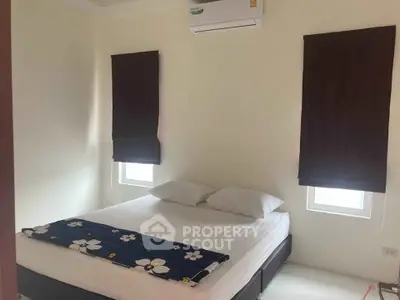 Cozy bedroom with air conditioning and minimalist decor, perfect for relaxation.