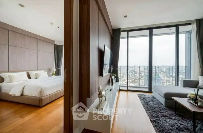 Luxurious modern apartment with spacious bedroom and living area, featuring floor-to-ceiling windows and city view.