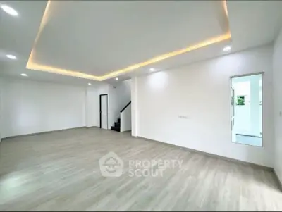 Spacious modern living room with elegant lighting and wooden flooring