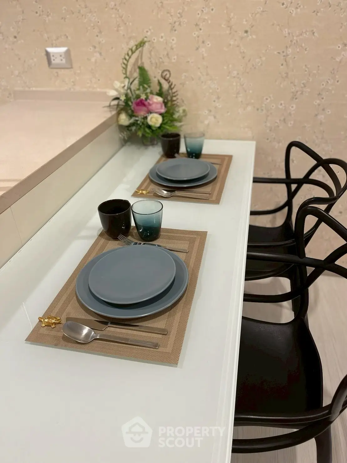 Stylish dining area with elegant table setting and modern chairs in a cozy home interior.