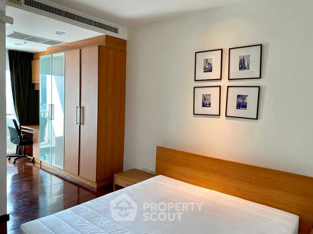 Spacious bedroom with modern wooden furniture and large wardrobe