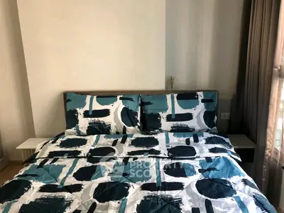 Cozy bedroom with modern bedding and natural light, perfect for relaxation.